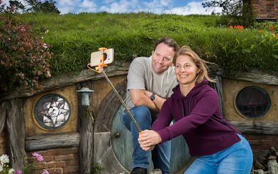 Couple taking selfie at Hobbiton Movie Set, New Zealand.