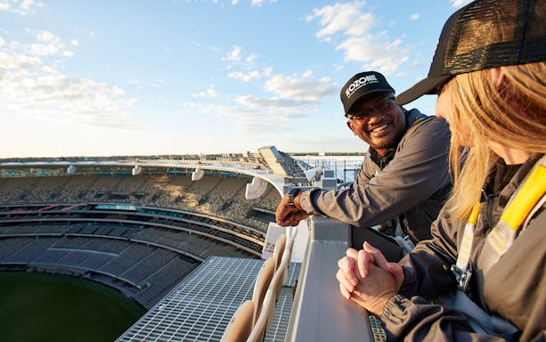 Visitors enjoying the view from the top of Optus Stadium during a guided tour in Perth.