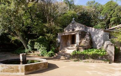 Convento dos Capuchos entrance surrounded by lush greenery in Sintra, Portugal.