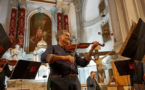 Violinist performing at Vivaldi Church concert in Venice, Italy.