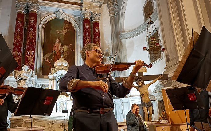 Violinist performing at Vivaldi Church concert in Venice, Italy.