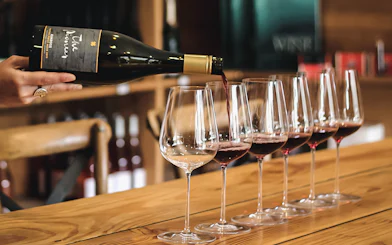 Wine being poured into glasses during a Queenstown gourmet food and wine tour.