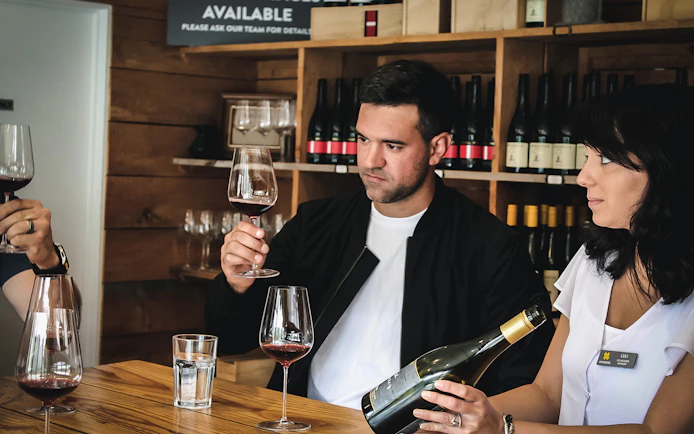 Wine tasting session during a gourmet tour in Queenstown.