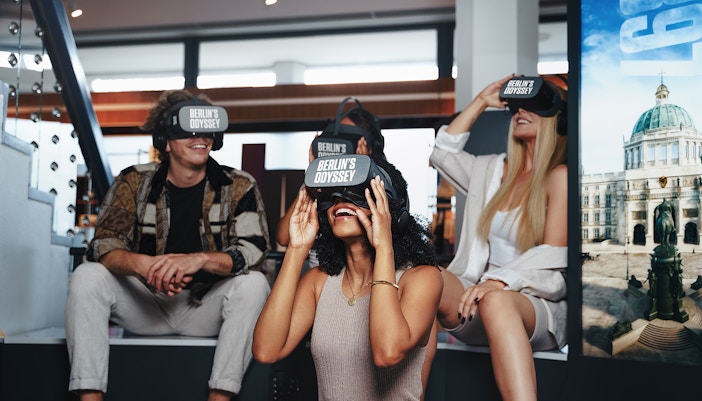 Mehrere Menschen tragen lachend VR-Brillen