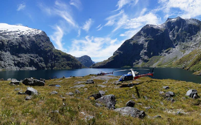 Helicopters on alpine landing with mountain and lake view, Queenstown Panorama Helicopter Tour.