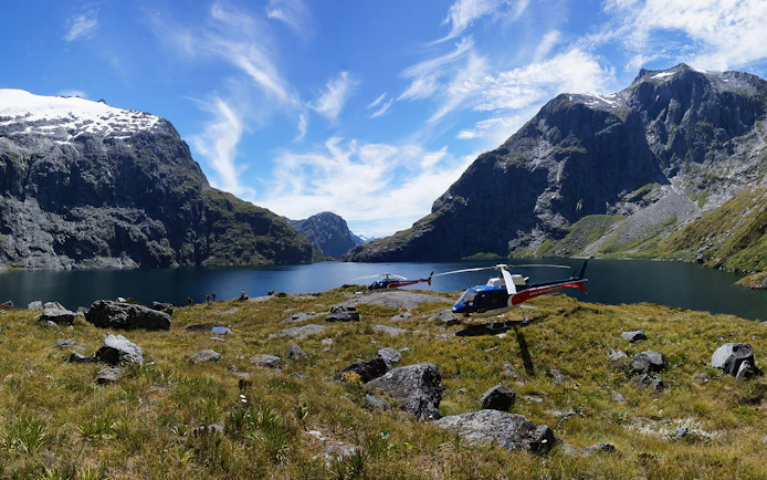 Helicopters on alpine landing with mountain and lake view, Queenstown Panorama Helicopter Tour.