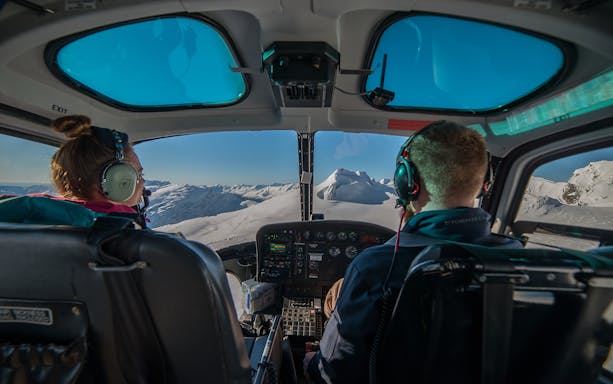 Helicopter cockpit view of snow-covered mountains during Queenstown Panorama Helicopter Tour.