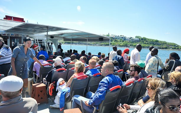 Cruise passengers on a boat in Istanbul with views of the Bosphorus and Golden Horn.