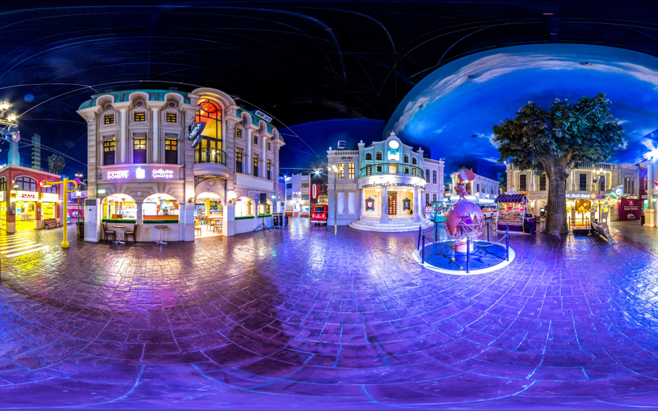 Kidzania Dubai indoor cityscape with illuminated buildings and activity areas.