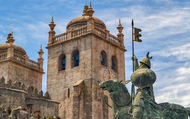 Porto Cathedral towers and equestrian statue on a day trip from Lisbon.