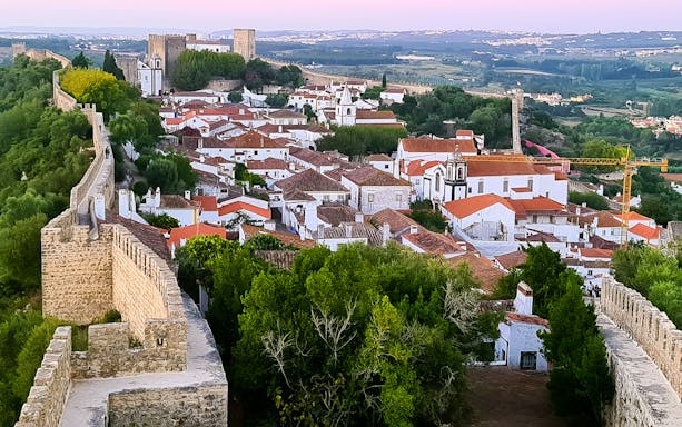 Óbidos town view with medieval walls and castle, Portugal.