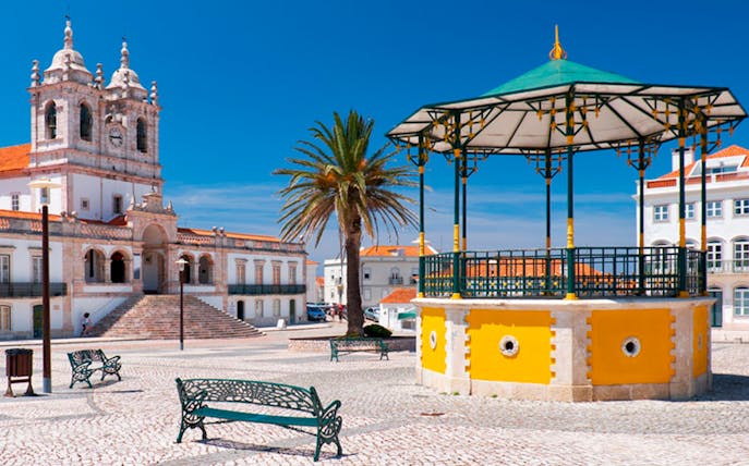 Nazaré town square with church and gazebo on Lisbon day tour.