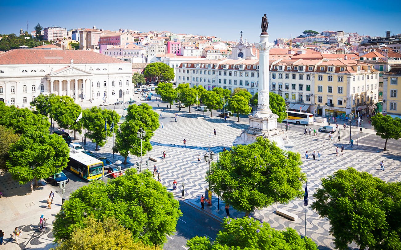 Lisbon's Rossio Square with column and surrounding architecture on a guided walking tour.