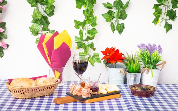 Portuguese snacks and wine on a checkered table during a Lisbon walking tour.