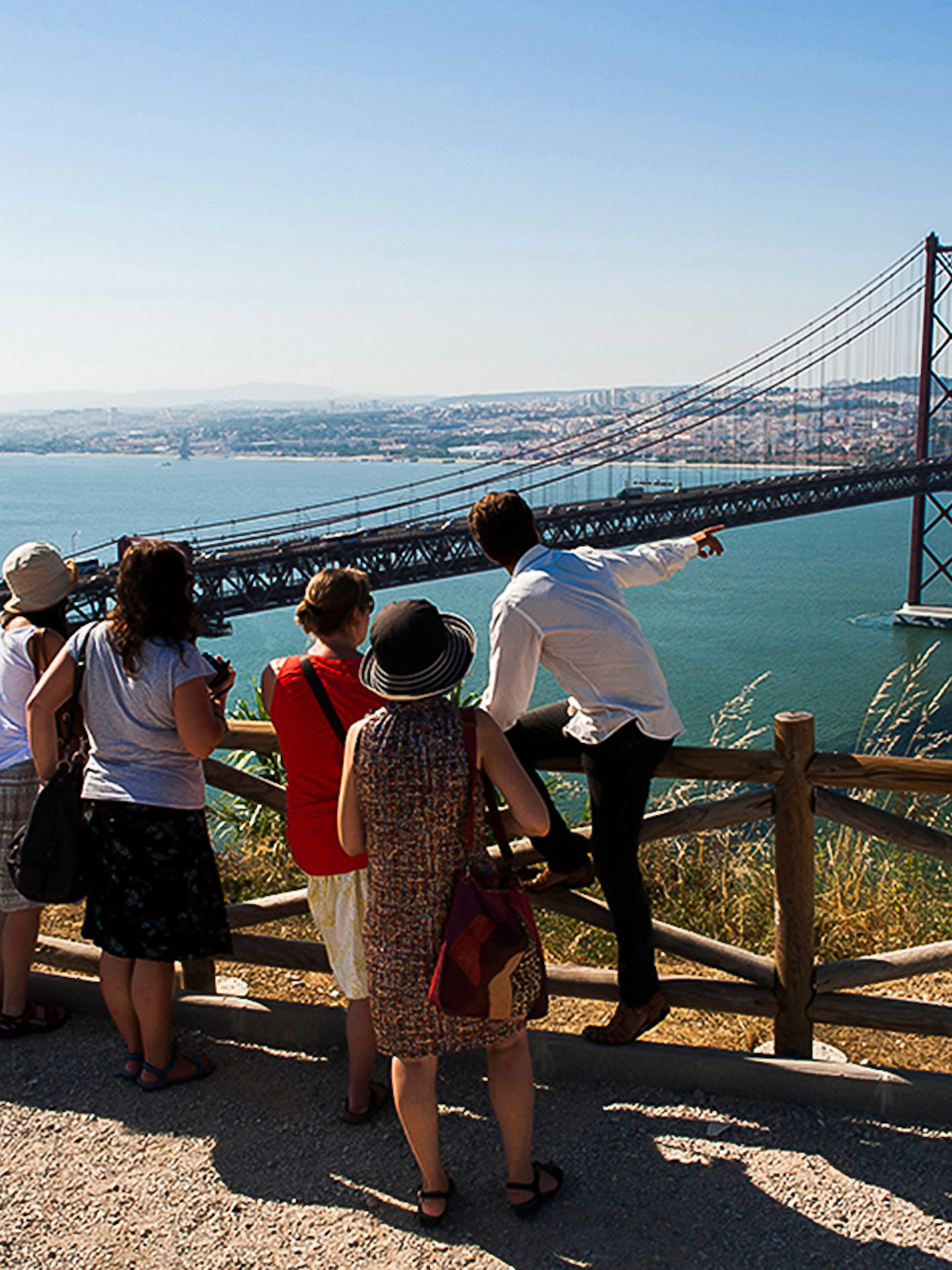 Group overlooking 25 de Abril Bridge on wine tour from Lisbon to Arrábida.