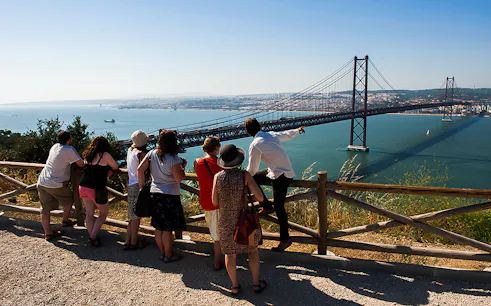 Group overlooking 25 de Abril Bridge on wine tour from Lisbon to Arrábida.