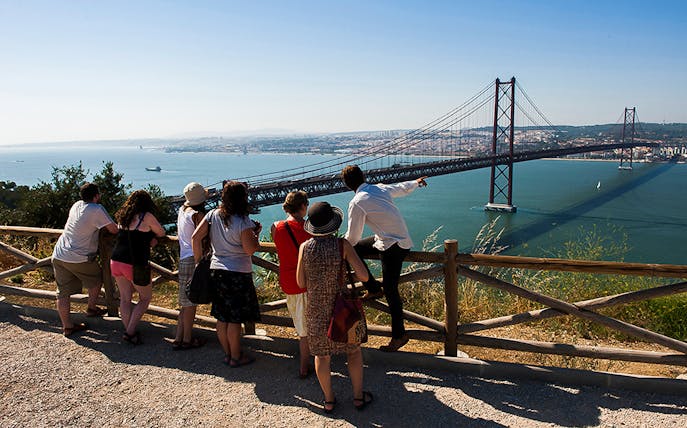 Group overlooking 25 de Abril Bridge on wine tour from Lisbon to Arrábida.
