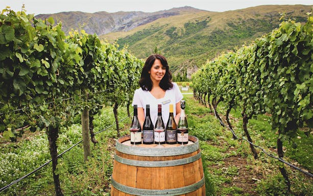 Wine tasting setup in Queenstown vineyard with guide.