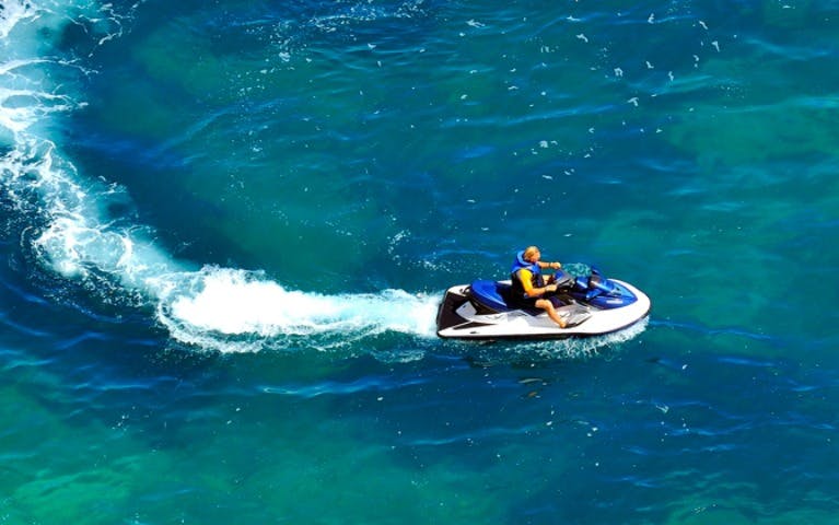 Jet ski rider on blue waters during Palm Jumeirah tour, Dubai.