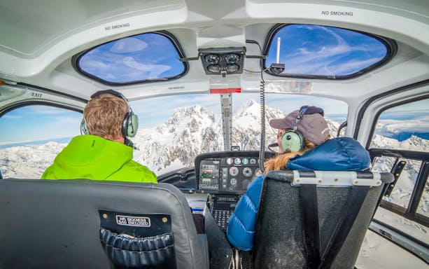 Helicopter cockpit view of Mount Cook with snow-covered peaks.