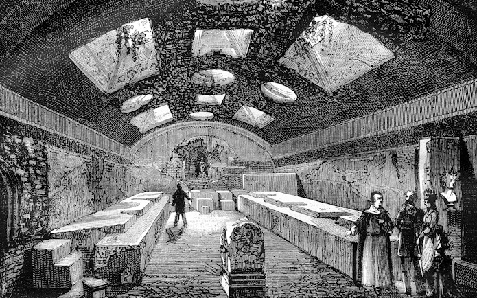 Ancient underground chamber with visitors, San Clemente, Rome.