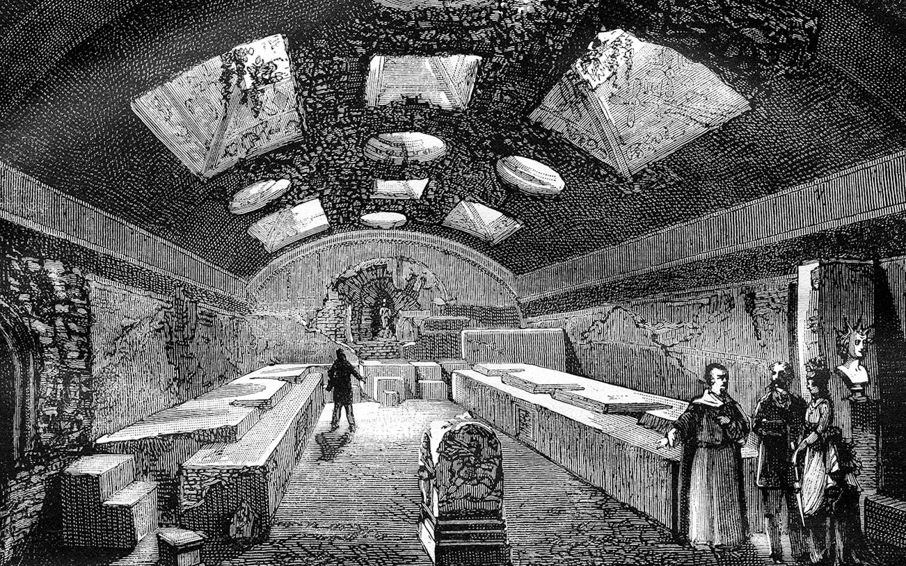 Ancient underground chamber with visitors, San Clemente, Rome.