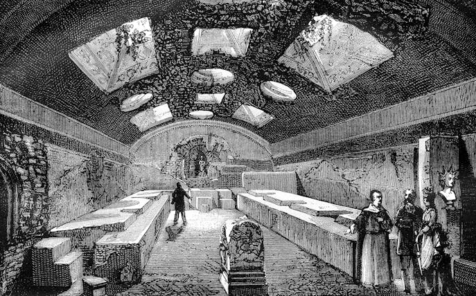 Ancient underground chamber with visitors, San Clemente, Rome.