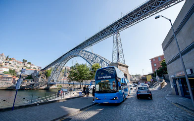 Hop-on hop-off bus near Dom Luís I Bridge in Porto, Portugal.