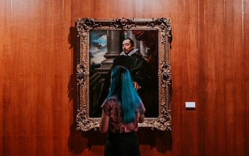 Visitor viewing a portrait at Calouste Gulbenkian Museum.