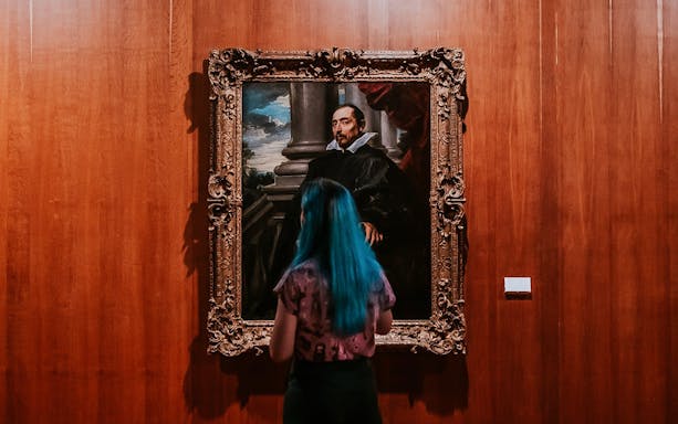 Visitor viewing a portrait at Calouste Gulbenkian Museum.