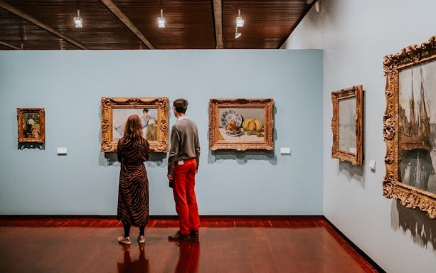 Visitors viewing paintings at Calouste Gulbenkian Museum, Lisbon.
