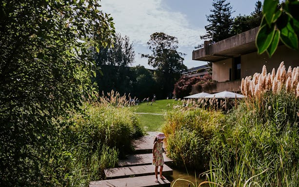 Child walking on a path in the gardens of Calouste Gulbenkian Museum, Lisbon.