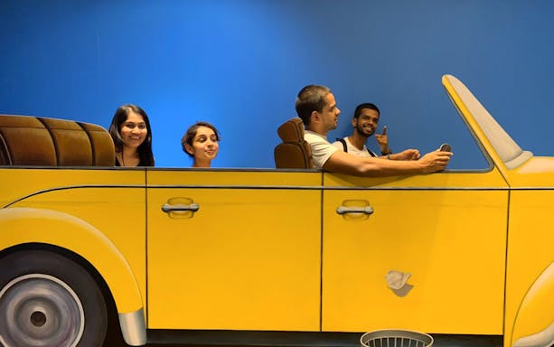 Visitors interacting with a 3D car exhibit at Illusion 3D Art Museum Kuala Lumpur.