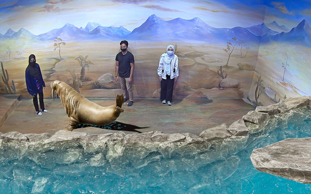 Visitors interact with 3D walrus art at Illusion 3D Art Museum Kuala Lumpur.