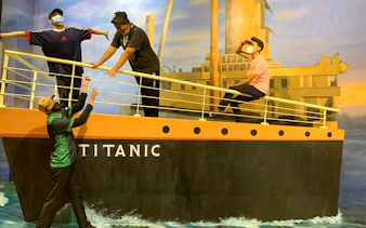 Visitors posing on a Titanic-themed 3D art installation at Illusion 3D Art Museum Kuala Lumpur.