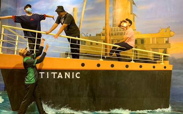 Visitors posing on a Titanic-themed 3D art installation at Illusion 3D Art Museum Kuala Lumpur.