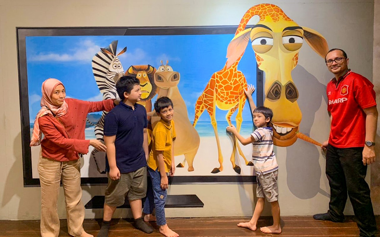 Visitors interacting with 3D animal art at Illusion 3D Art Museum Kuala Lumpur.