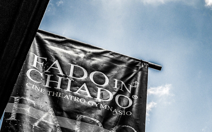 Banner for Fado in Chiado at Cine Theatro Gymnasio against blue sky
