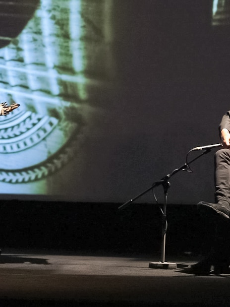 Musicians performing Fado in Chiado, Lisbon, with guitars on stage.