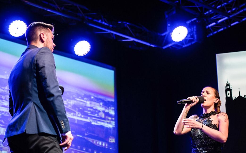 Fado singers performing on stage in Chiado, Lisbon.