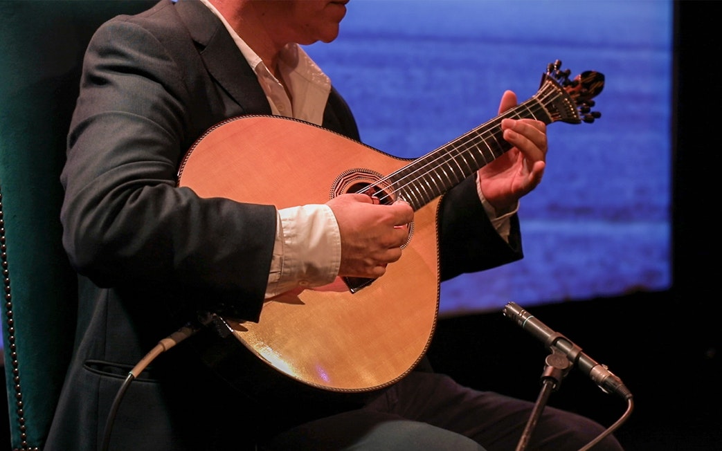 Musician playing Portuguese guitar at Fado in Chiado, Lisbon.