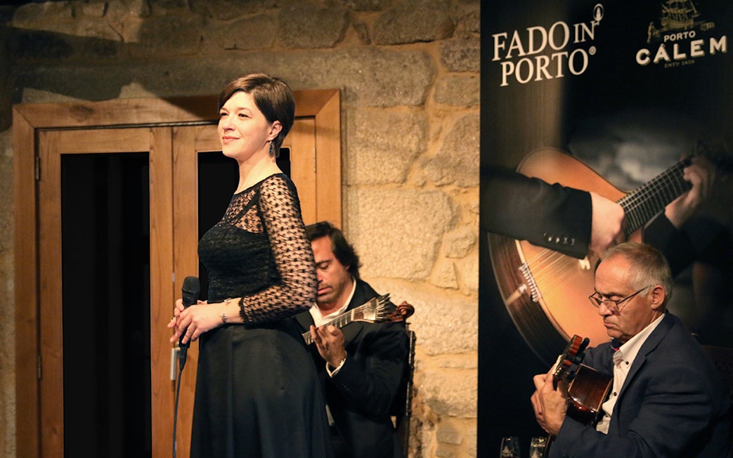 Fado concert in Porto wine cellar with musicians performing.