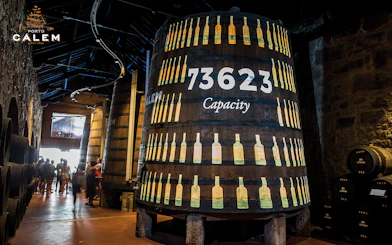 Porto wine cellar with large barrels, venue for Fado concert tickets.