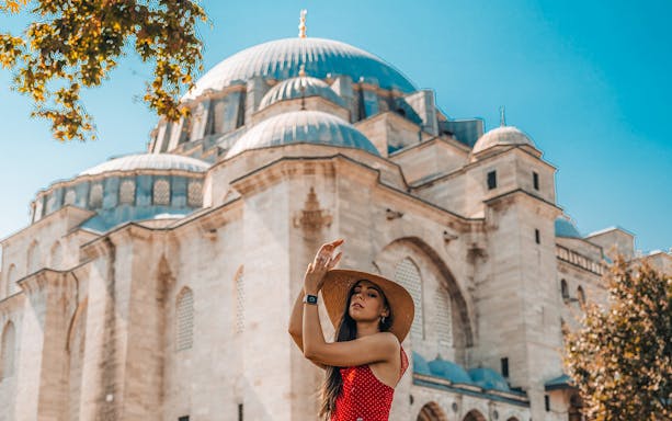 Woman in front of a historic mosque in Istanbul during a half-day walking tour.