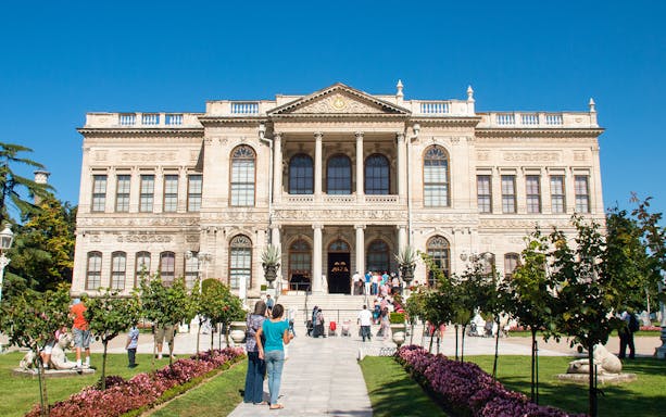 Dolmabahçe Palace entrance with visitors, Istanbul boat tour.