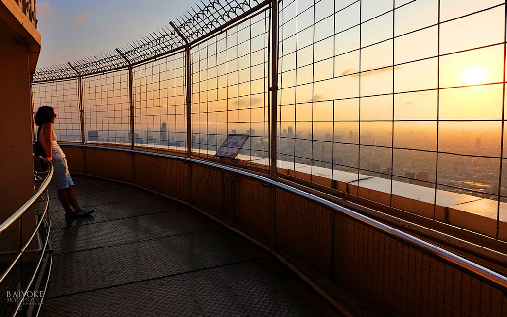 Baiyoke Sky Hotel observatory view at sunset, Bangkok skyline in the background.