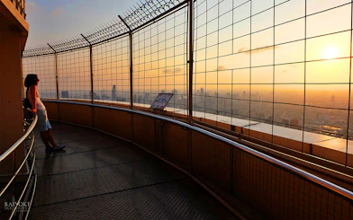 Baiyoke Sky Hotel observatory view at sunset, Bangkok skyline in the background.