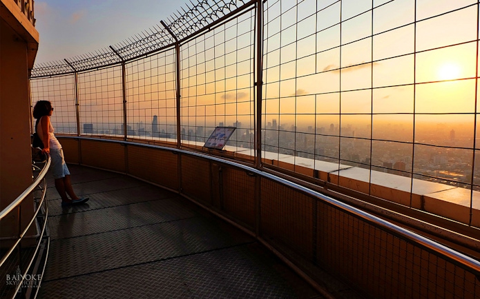 Baiyoke Sky Hotel observatory view at sunset, Bangkok skyline in the background.