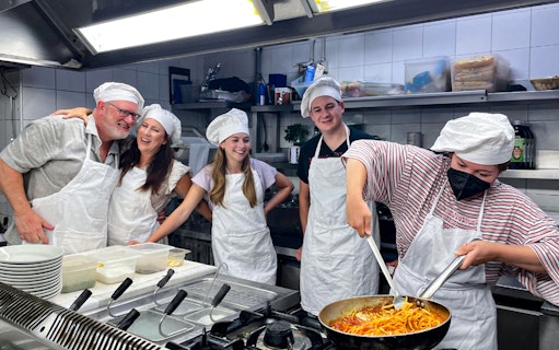 Cooking class participants making pasta in the Roman Jewish Ghetto kitchen.