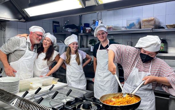 Cooking class participants making pasta in the Roman Jewish Ghetto kitchen.